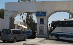 Vehicles queue at the Jordanian side of the King Hussein Bridge (also known as Allenby Bridge) crossing between the West Bank and Jordan on July 19, 2022. The border crossing, which serves as a border crossing between Israel and Jordan mainly for the Palestinians and foreign tourists, has witnessed an issue with crowding with passengers stuck on the Jordanian side. (Photo by Khalil MAZRAAWI / AFP)