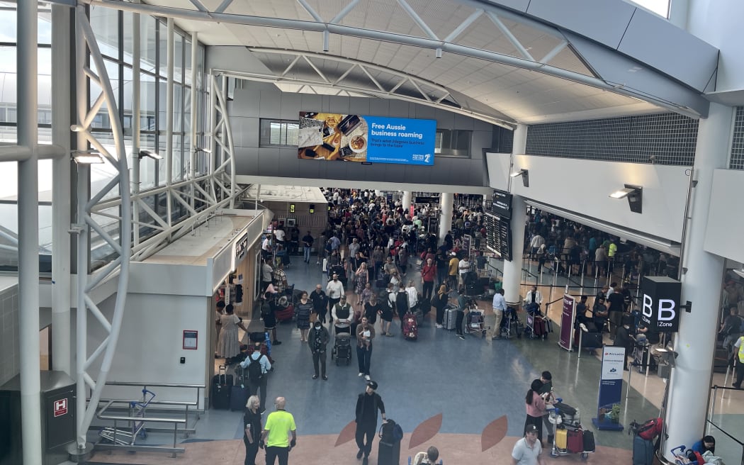 Crowds at Auckland Airport as travelers head away for Christmas 2024.