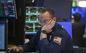 A trader works on the floor of the New York Stock Exchange (NYSE) at the opening bell on April 8, 2025, in New York City. Wall Street stocks surged higher early Tuesday as global markets rallied following deep losses in hopes of trade agreements that would remove US President Trump's heavy tariffs. All three major US indices were up more than three percent in early trading as Trump described an upbeat call with the head of South Korea while US Treasury Secretary Scott Bessent said Japan had sought quick negotiations. (Photo by ANGELA WEISS / AFP)
