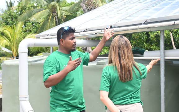 David Kakiakia shows ChildFund NZ programmes director Maria Trogolo solar water distillation equipment.