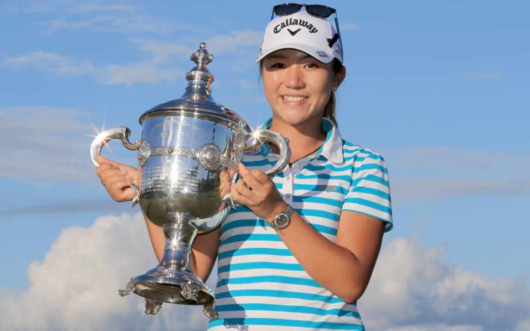 Lydia Ko poses with the Rolex Player of the Year trophy, which she won this week.