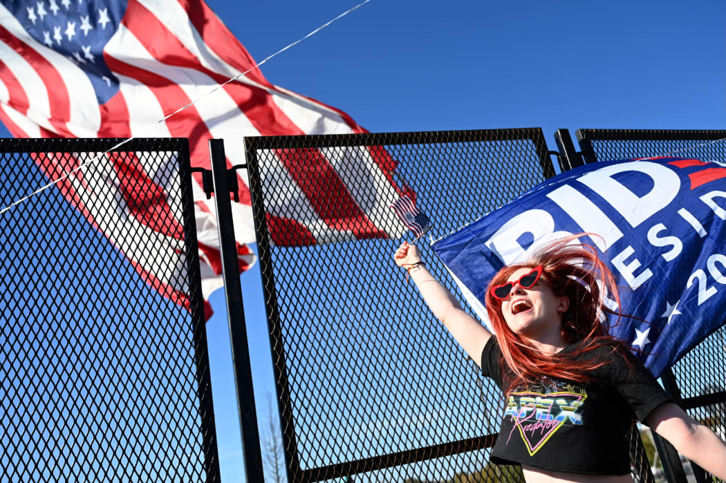 Biden supporter Mandy McHale cheers as she hears Joe Biden is the president-elect while sitting outside his election night event site in Wilmington, Delaware, on November 7, 2020.