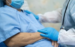 Doctor using stethoscope to checking Asian senior or elderly old lady woman patient wearing a face mask in hospital for protect infection Covid-19 Coronavirus.