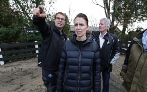 Chris Allen points out the damage caused by recent flooding to New Zealand Prime Minister, Jacinda Ardern.
