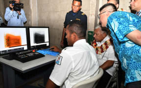 Prime Minister Frank Bainimarama (with garland) is shown what the new non-intrusive inspection x-ray can do at the Suva Wharf this week.