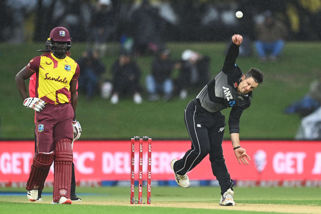 Hamish Bennett bowls in the rain during the New Zealand Black Caps v West Indies match.