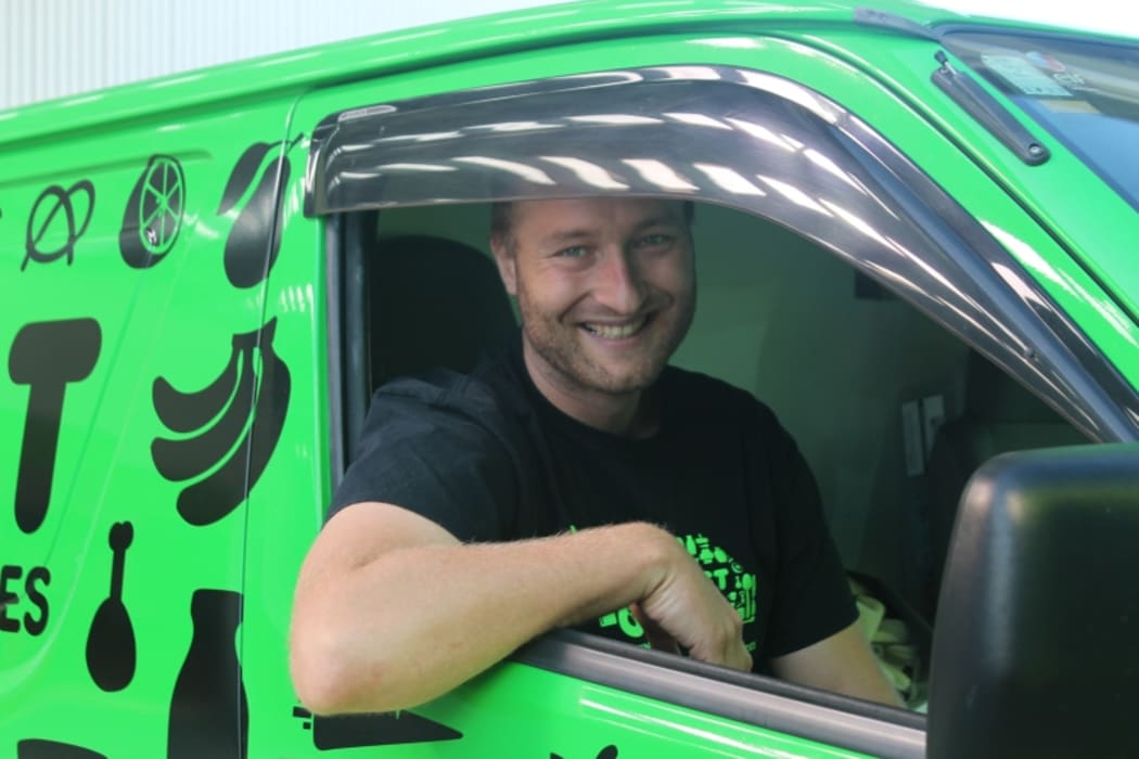 An image of delivery driver Sam Mentink in the cabin of the Kiwi Harvest van.