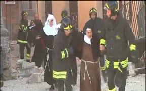 Italian emergency workers help nuns in Norcia after the 6.6 earthquake.