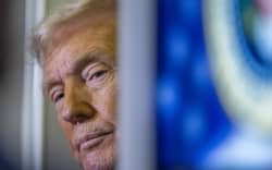 US President Donald Trump speaks to journalists aboard Aire Force One as he travels from West Palm Beach back to Washington on March 9, 2025. (Photo by ROBERTO SCHMIDT / AFP)
