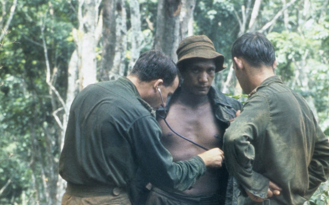 An Australian medical officer treating the New Zealand W Company during a resupply in the field during the Vietnam War.