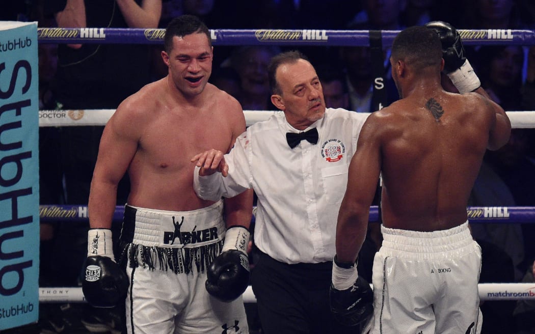 The referee breaks up Anthony Joshua and Joseph Parker