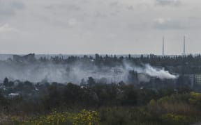 Smoke raises up from Bakhmut in the Donetsk region, a city under Russian offensive pressure despite the retreat of Moscow's troops in the northeast.