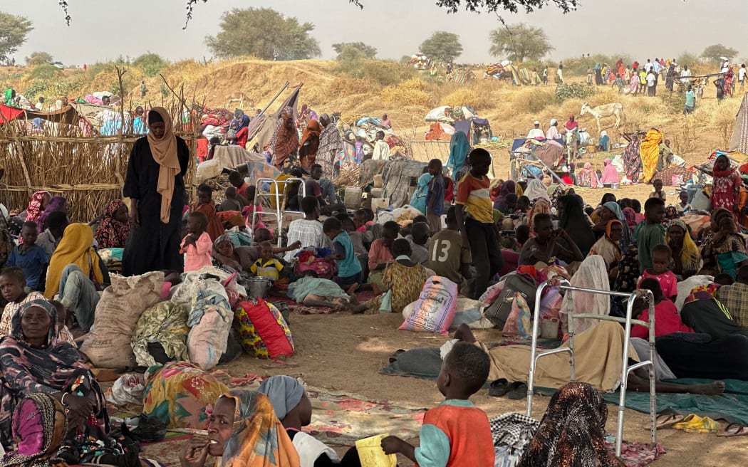 People who fled the Zamzam camp for displaced people after it fell under RSF control, rest in a makeshift encampment in an open field near the town of Tawila in war-torn Sudan's western Darfur region on 13 April, 2025.