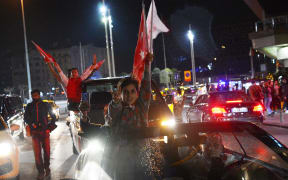 Supporters of Turkish President Tayyip Erdogan celebrate victory in the Turkey's constitutional referendum.