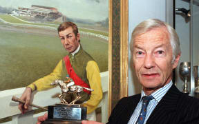 Racing legend Lester Piggott, poses for the media in this 1998 file image, at a preview of Sotheby's annual racing sale, which features some of his trophies and memorabilia. The collection, includes his 1966 Champion Jockey Trophy which is expected to fetch £3,000-£4,000 and a bronze sculpture of two horses by the French artist Mene - thought to be worth £8,000-£12,000.        == UK OUT == (Photo by FIONA HANSON / PA / AFP)