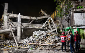 Rescue personnel inspect the site after a building collapsed at an Islamic boarding school in Sidoarjo, East Java province on September 29, 2025, injuring a number of students and trapping several others under the rubble. (Photo by Juni KRISWANTO / AFP)