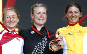 Linda Villumsen, centre, with silver medalist Emma Pooley, left, and Katrin Garfoot who took bronze.