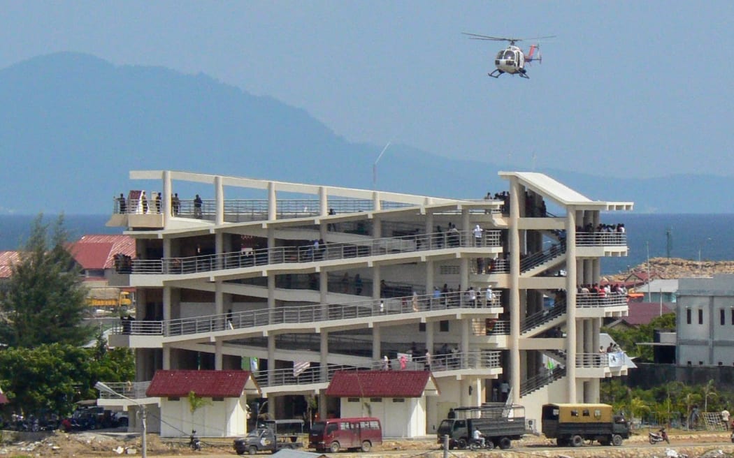 Police helicopter landing on a new tsunami vertical evacuation building during Banda Aceh’s first tsunami drill, 2008.