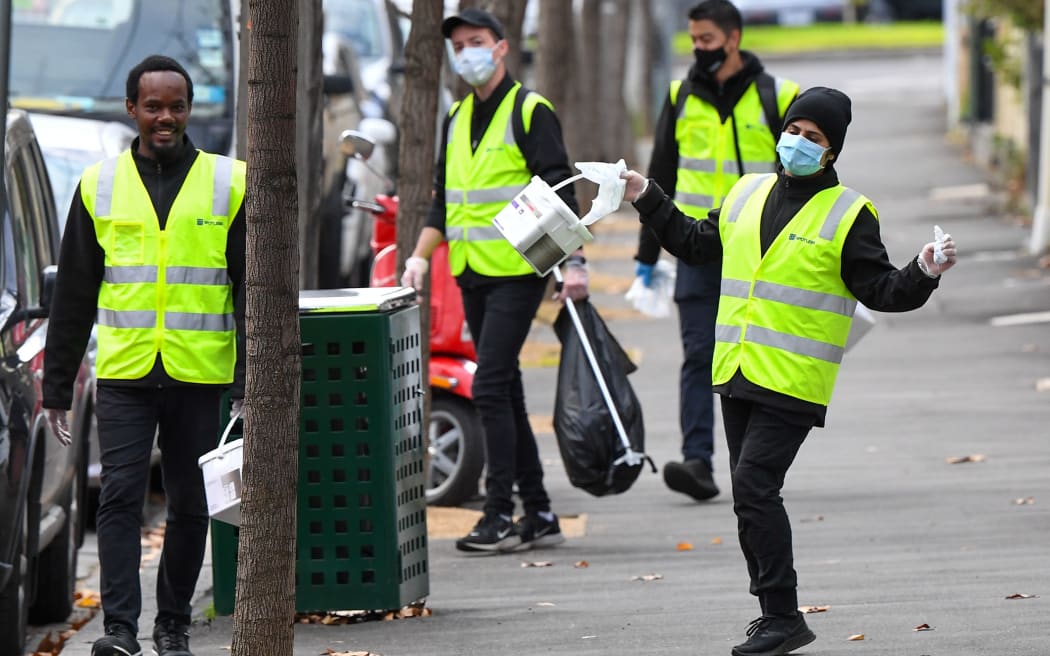 Cleaners wipe down amenities in Melbourne on July 9, 2020 as the city re-enters a city wide lockdown after a fresh outbreak of the COVID-19 coronavirus.
