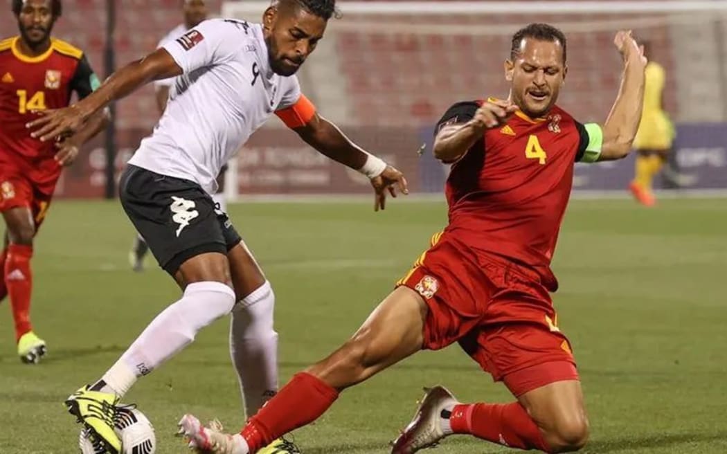 PNG captain Alwin Komolong tackles Fiji skipper Roy Krishna.