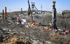 Members of a rescue team work at the site of a gold mine explosion where 22 miners are trapped underground in Qixia.