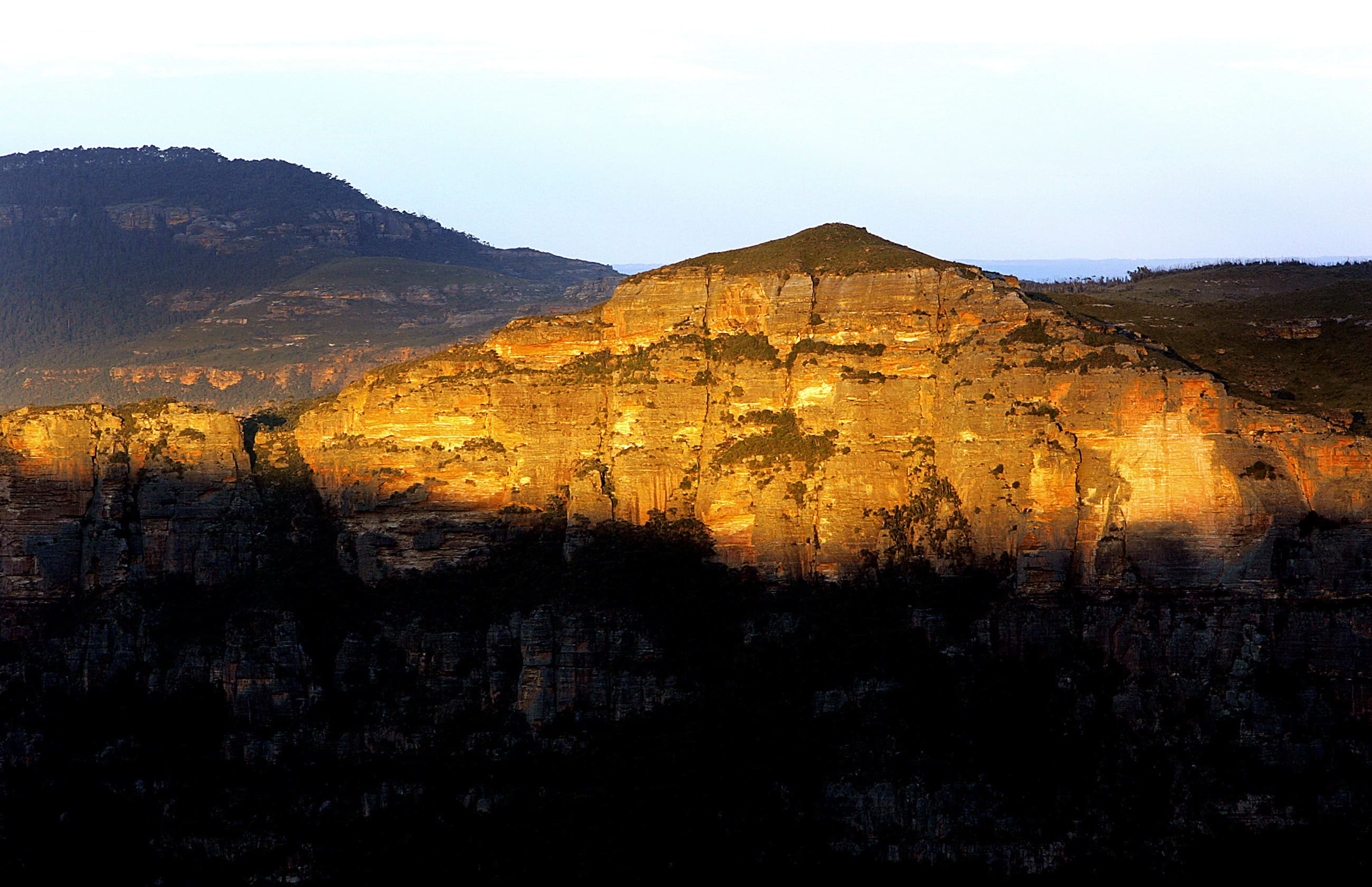 The sun sets across a mountain top in the Blue Mountains National Park, inland from central Sydney.