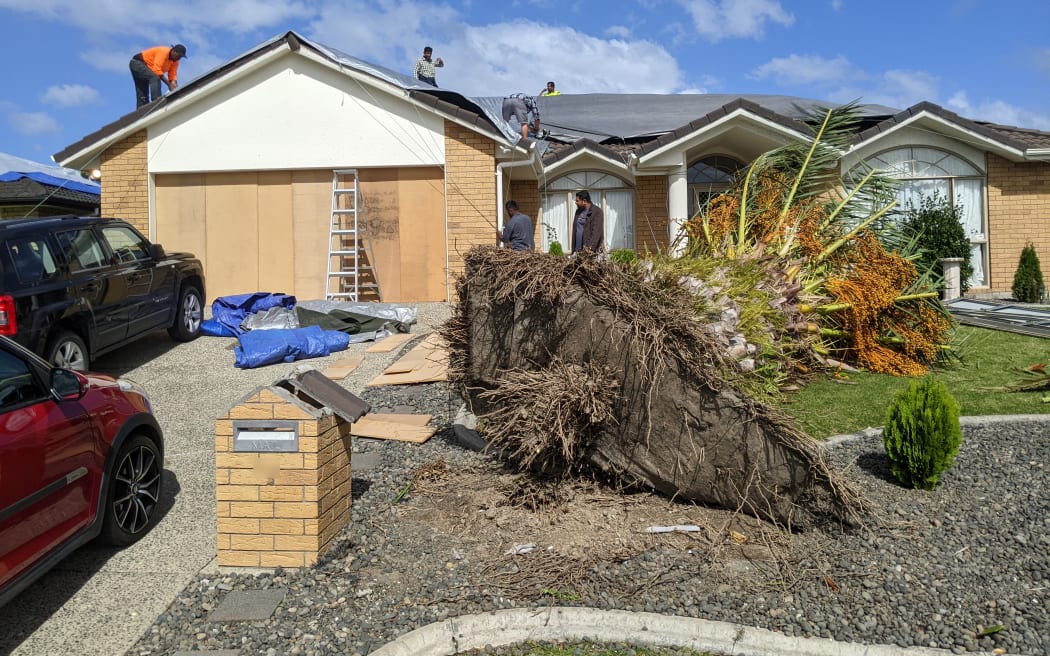 A tornado destroyed the roof and uprooted a large palm tree at this property on Attymon Lane, East Tāmaki, Auckland.
