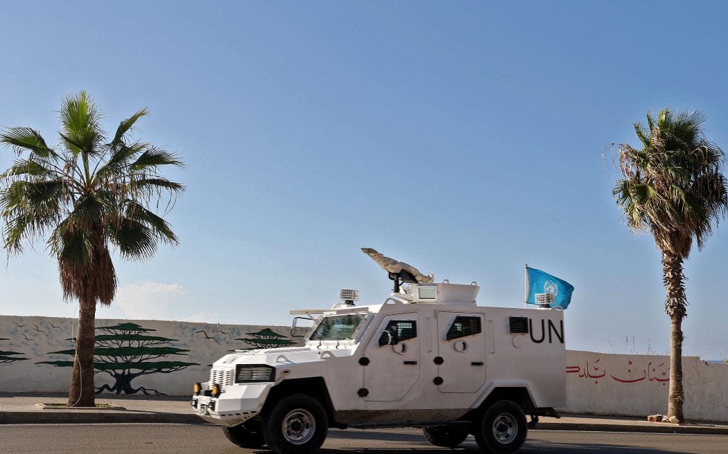 A UNIFIL armoured vehicle drives through Beirut as part of a UN peacekeeping convoy heading towards south Lebanon, on November 12, 2024, amid the ongoing war between Israel and Hezbollah. (Photo by PATRICK BAZ / AFP)
