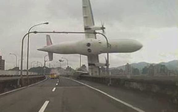 A TransAsia Airways plane clipped a bridge and crashed into a river near the capital, Taipei.