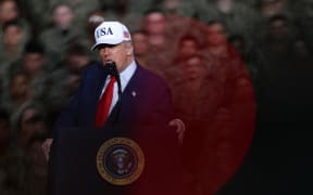 U.S. President Donald Trump delivers a speech aboard the nuclear-powered aircraft carrier USS George Washington (CVN-73) in Yokosuka City, Kanagawa Prefecture, Japan, on October 28, 2025. ( The Yomiuri Shimbun ) (Photo by Kunihiko Miura / The Yomiuri Shimbun via AFP)