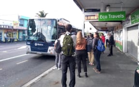 Commuters take a replacement bus service on Dominion Road. NZ Bus services are cancelled due to the industrial dispute.