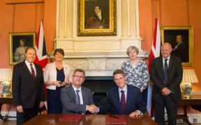 Britain's Prime Minister Theresa May stands with members of her new government.