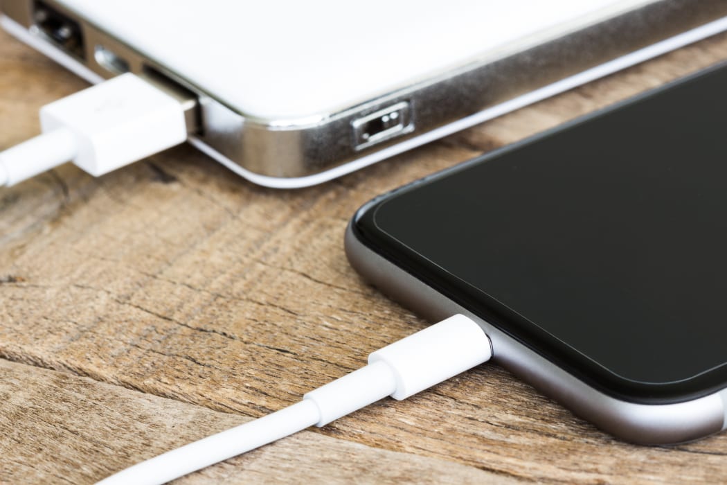 closeup phone charging white power bank portable devie