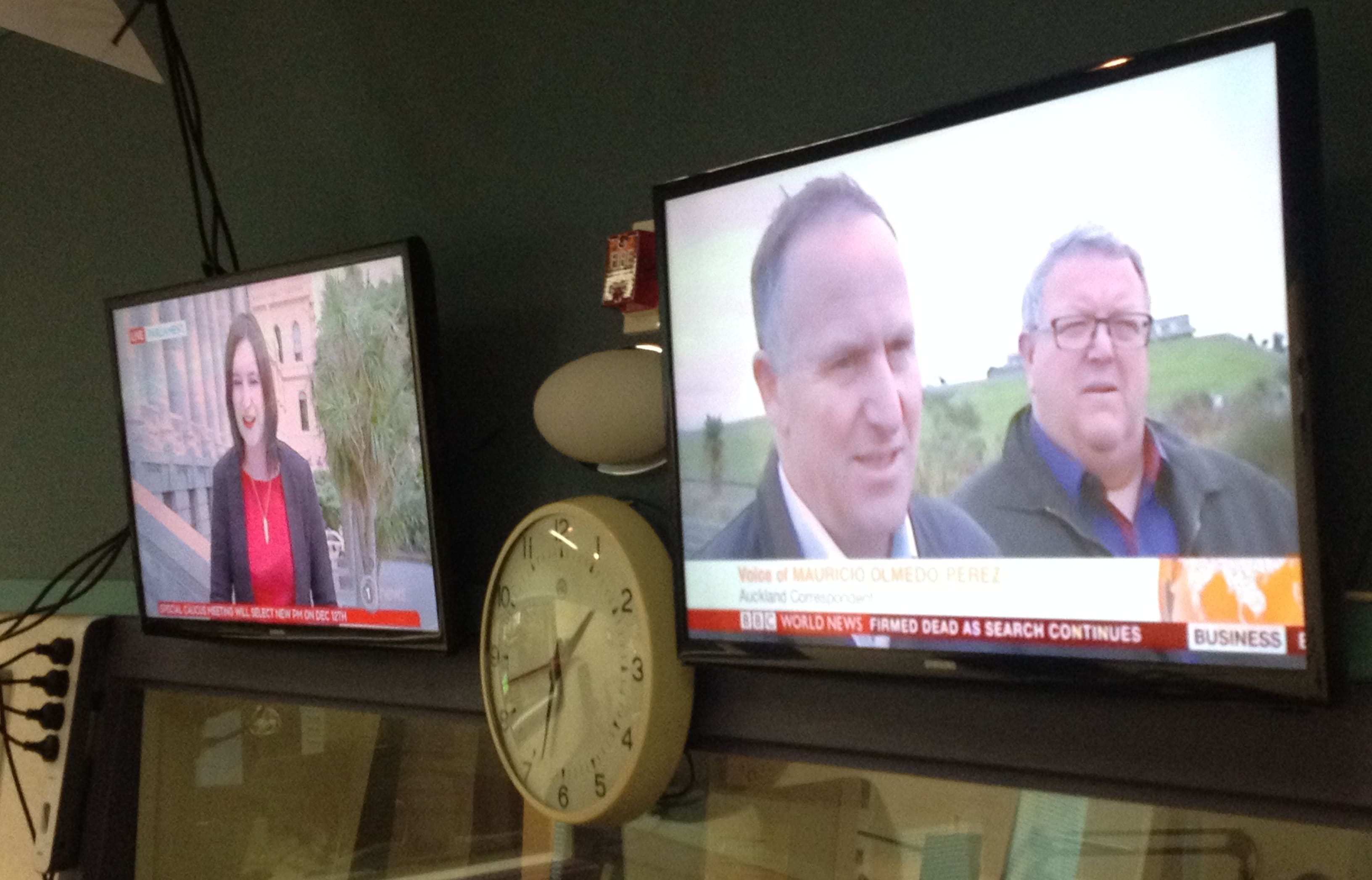 TVNZ 1 and BBC World with the breaking news on screen in an RNZ studio.