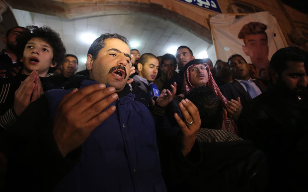 Supporters and family members of Maaz al-Kassasbeh say prayers following his reported killing.