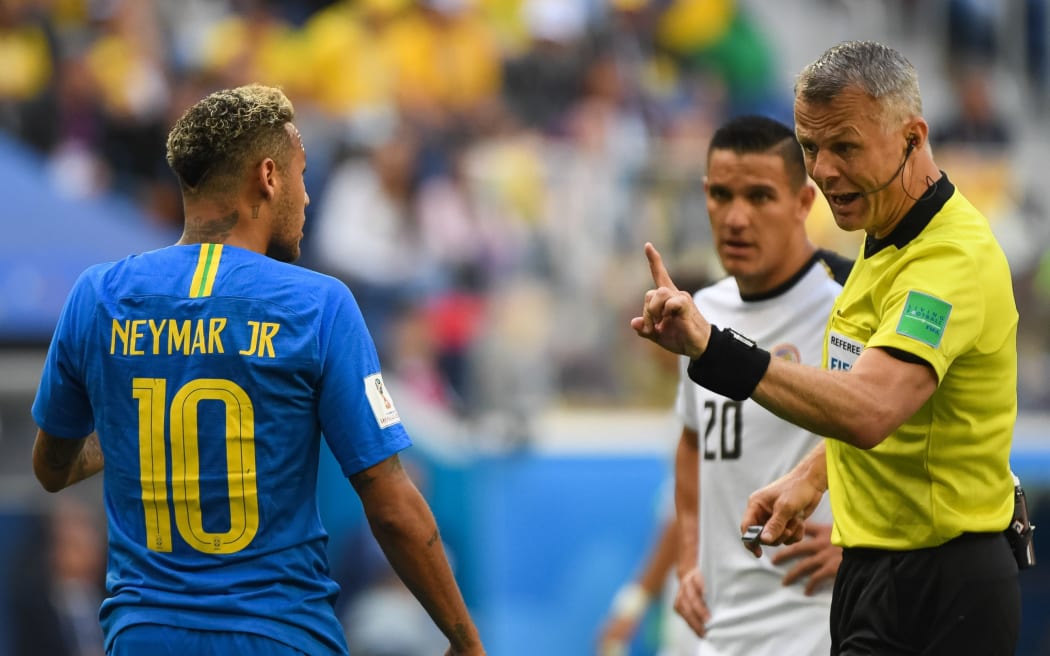 Brazilian star Neymar is warned by the referee to be quiet.