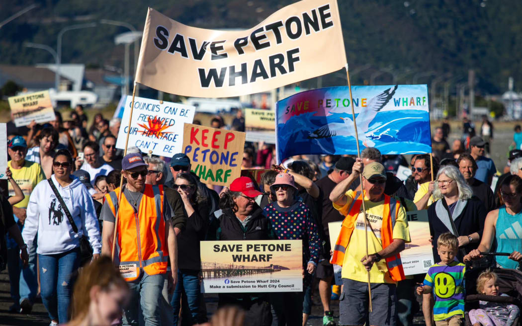 People protesting plans to demolish Petone Wharf walk along Petone Beach 28 April 2024.
