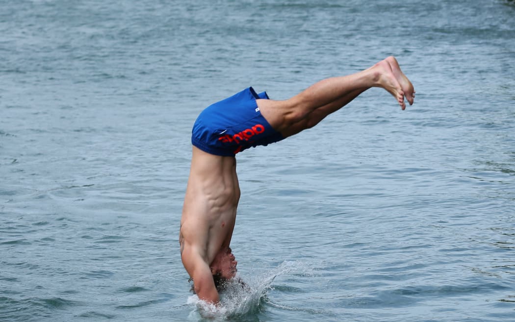 Gillies Kaka takes the plunge into Wellington Harbour.