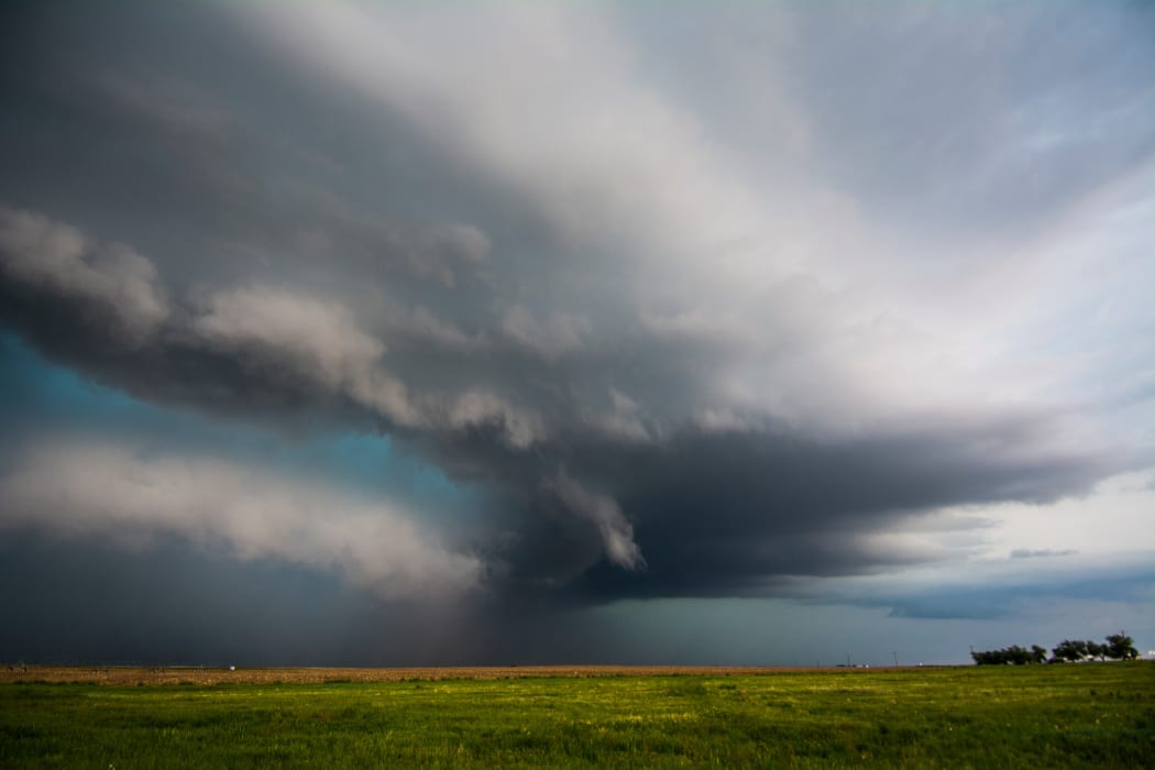 A supercell storm assumes a green colour after producing tornadoes near Felt, Oklahoma
