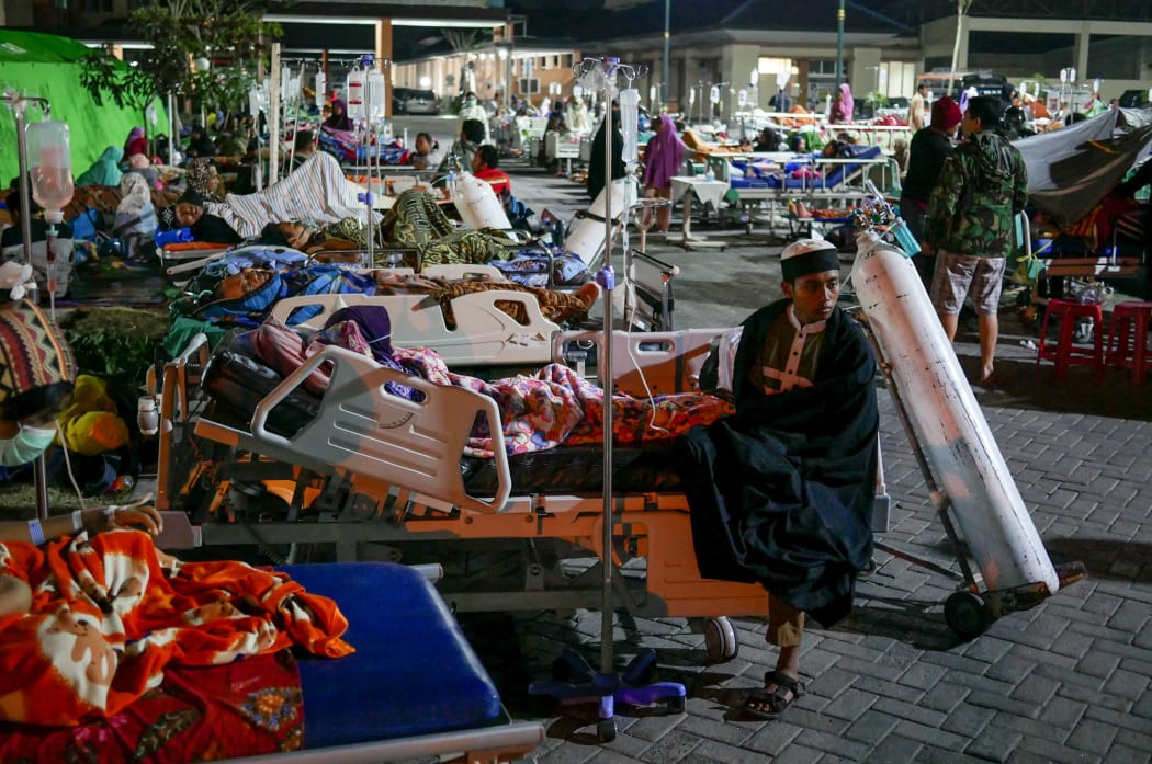 Patients are seen outside of a public hospital in Lombok, Indonesia after the 6.9 magnitude quake hit.