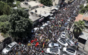 Mourners carry the bodies of Palestinians killed in clashes the previous day in the Israeli military operation during the funeral in Jenin in the occupied West Bank on 5 July 2023.