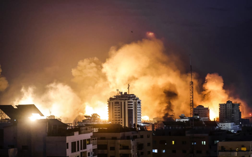 A fireball erupts during Israeli bombardment of Gaza City on 9 October 2023. Israel imposed a total siege on the Gaza Strip on October 9 and cut off the water supply as it kept bombing targets in the crowded Palestinian enclave in response to the Hamas surprise assault.