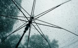 An umbrella in heavy rain.