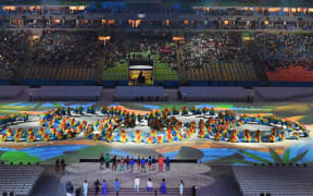 Dancers form the shape of the Olympics rings logo at the Rio 2016 closing ceremony.