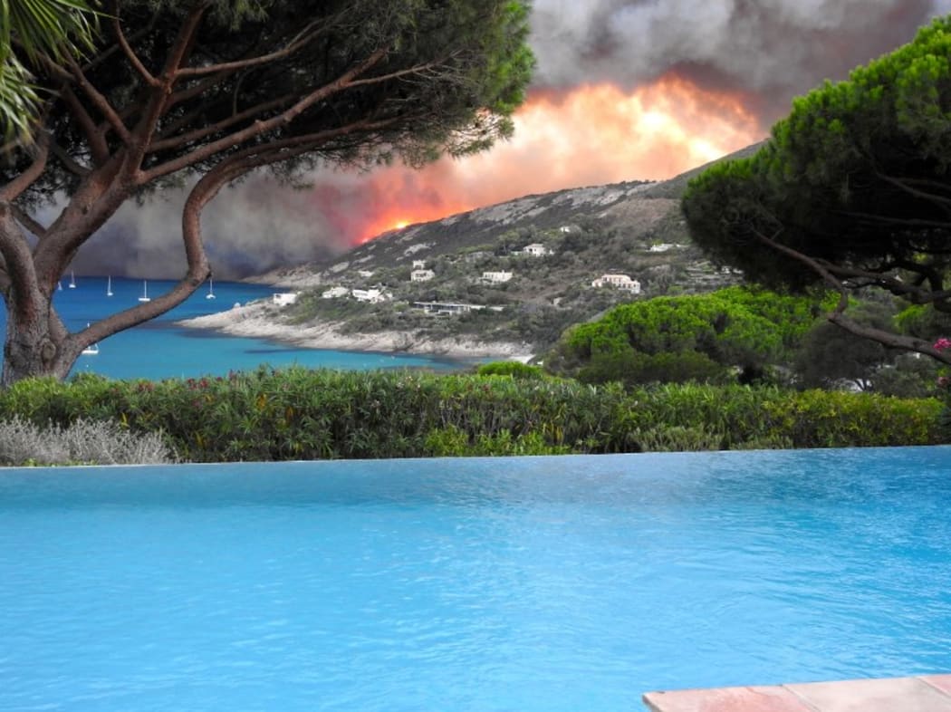 Smoke billows above Ramatuelle, southern France as a violent wildfire hit the area.