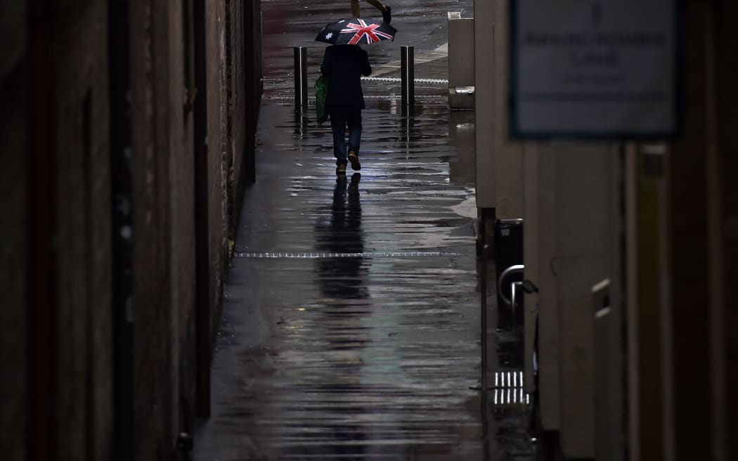 Man with umbrella, flooding in New South Wales
