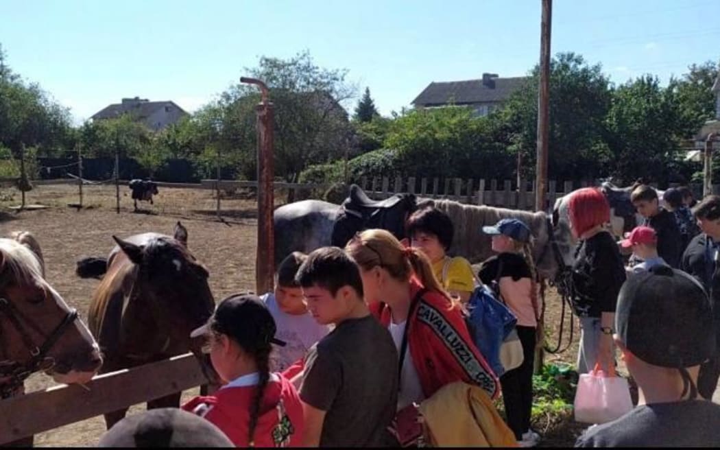 Children visiting horses in Izmail, Ukraine