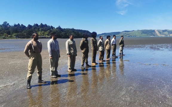 Soldiers stand at attention (dramatic re-enactment).