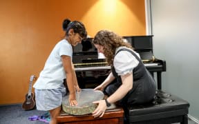 Kiara's music therapist Aliss Pollock has helped her learn about various instruments.
