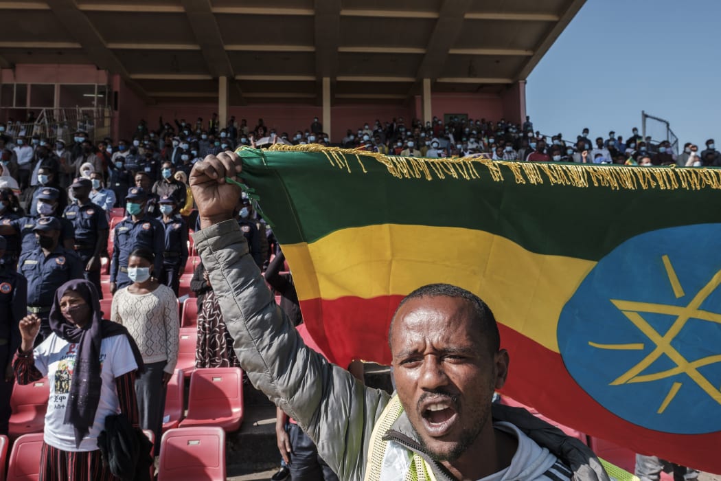 A man holds an Ethiopian national flag during a blood donation rally in Addis Ababa, as hundreds of Ethiopians gathered in the capital on 12 November 2020, to donate blood for troops fighting in the northern Tigray region.